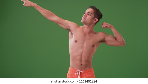 Attractive Hispanic man in swimsuit flexing muscles on green screen - Powered by Shutterstock