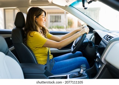 Attractive Hispanic Woman Feeling Happy And Enjoying Driving A Car Drive During The Day