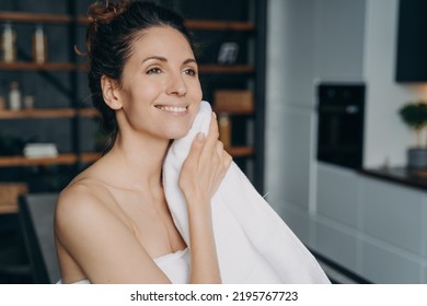 Attractive Hispanic Woman Is Wiping Face With Towel After Washing. Happy Girl Takes Shower At Home And Doing Skin Care. Hygiene, Freshness And Female Spa Procedures. Beauty Routine.