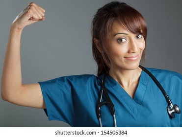 Attractive Indian doctor woman posing in a studio in front of a background