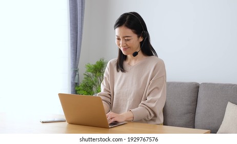 attractive japanese woman working in the in living room