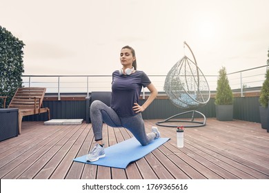 Attractive lady in sportswear doing exercise on yoga mat and closing eyes peacefully - Powered by Shutterstock