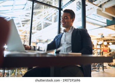 Attractive Latin American Young Dark-haired Male Engineer With A Pleased Smile Working In His Office