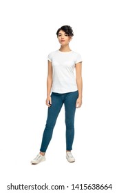 attractive latin brunette woman standing in blue jeans and white t-shirt isolated on white