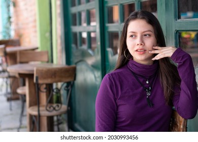 Attractive Latina Woman In An Alleyway Posing With Her Gaze