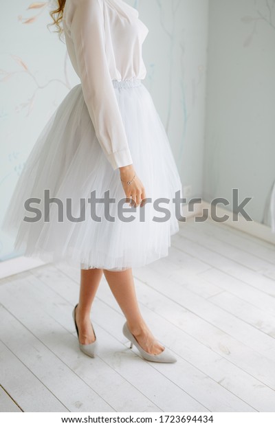 Attractive\
legs of fashion models in tulle skirts\
indoor