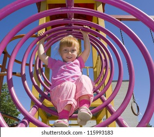 Attractive Little Girl On Outdoor Playground Equipment