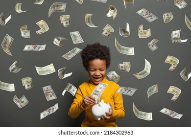 Attractive Little Kid Laughing On Falling Us Dollar Money Rain On Black Background