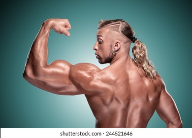 Attractive Male Body Builder On Blue Background