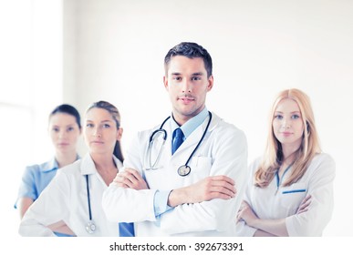 Attractive Male Doctor In Front Of Medical Group