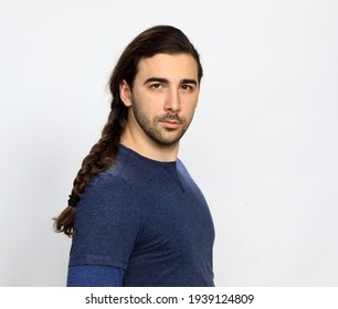 Attractive Male Model With Long Hair And Beard Is Posing In Studio. Style, Trends, Fashion Concept.