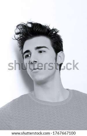 Similar – Boy with a white T-shirt in front of a dark wall