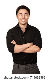 Attractive Man In A Black Shirt And Grey Pants, Standing With A Big Smile Against A White Background,