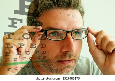 Attractive Man Checking Vision Trying Glasses At Optometrist . Cheerful And Handsome Guy On His 40s During Optical Examination Testing Spectacles For Correcting Myopia In Eyes And Health Care