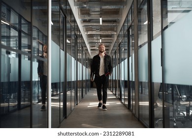 Attractive man facing camera in modern office - Powered by Shutterstock