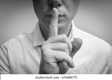 Attractive Man With Finger On Lips Making Silence Gesture. Shh!!!