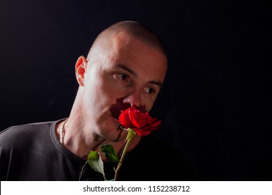 Attractive Man With Flowers In His Hand Is Waiting. Waits For The Woman. She Is Not Coming. Depressed Young Man Holding Single Rose. Romantic Suprise