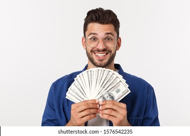 Attractive Man Is Holding Cash Money In One Hand, On Isolated White Background