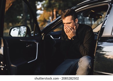 Attractive Man Look Tired And Sad. Man Closed Eyes By His Hands. Male Sitting In Black Car. Hands On Face. Depression.