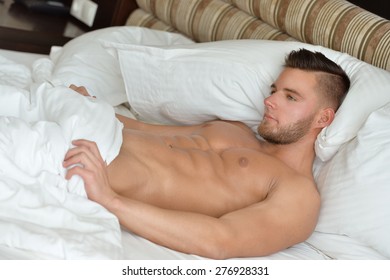 Attractive man lying in his bed