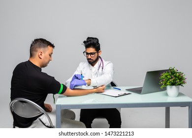 Attractive Man Patient Getting Vaccine On Her Arm By A Indian Doctor In Hospital