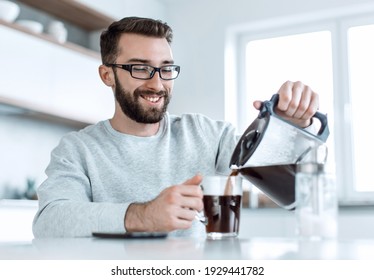 attractive man pouring himself a Cup of morning coffee