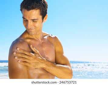 Attractive Man Sunbathing With Sunscreen On His Face