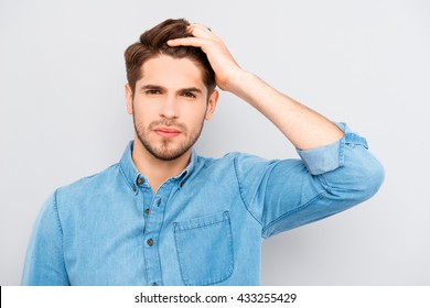 Attractive Man Touching His Hair On Gray Background