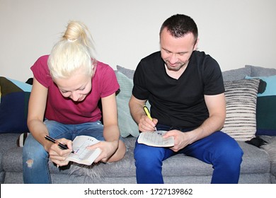 Attractive Man And Young Woman Solving Painted Crossword At Home Quarantine