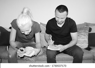 Attractive Man And Young Woman Solving Painted Crossword At Home Quarantine