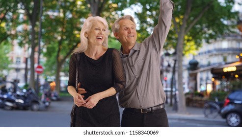 Attractive Mature Couple Hailing A Cab In Paris