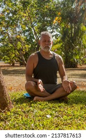 Attractive Mature Man Meditating In The Garden Of His House