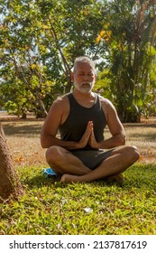 Attractive Mature Man Meditating In The Garden Of His House