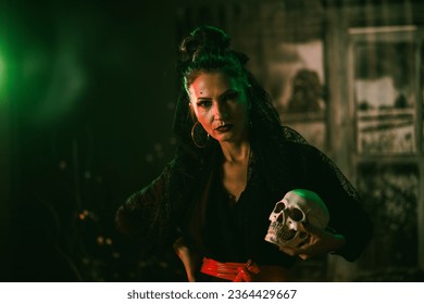 An attractive mature woman holding skull at Halloween party. Looking at camera. - Powered by Shutterstock
