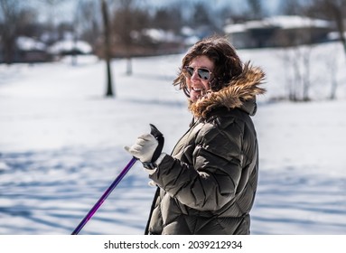 Attractive Mature Woman In Winter Coat Smiling At Camera While Skiing; Winter In Midwest