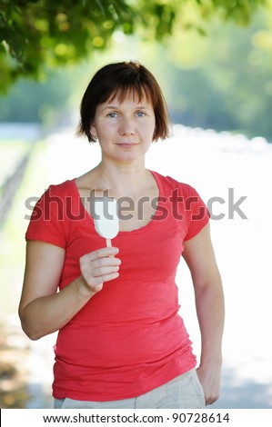 Attractive middle age woman holding ice cream
