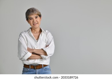 Attractive Middle Aged Asian Woman With Folded Arms Isolated On White Background