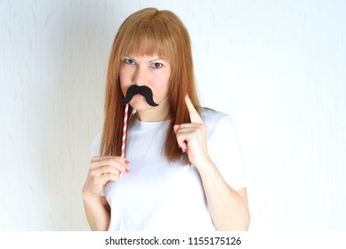 Attractive Middle Aged Woman Having Fun With A Fake Moustache. Woman In  Period Menopause Pointing With Finger Up,threatening With His Forefinger Upwards,hand Sign Idea, Positive Confident Gesture.