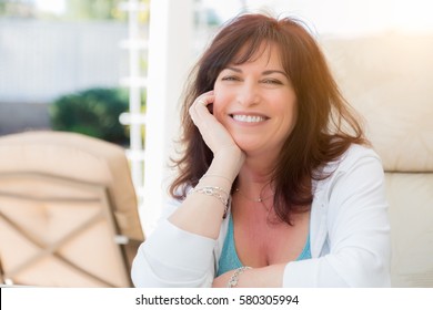 Attractive Middle Aged Woman Smiles On The Patio. - Shutterstock ID 580305994