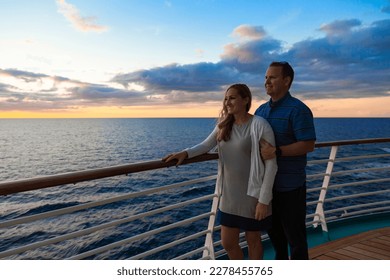 Attractive middle-aged couple enjoying the sunset view from the deck of a cruise ship while on a romantic vacation together	 - Powered by Shutterstock