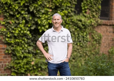 Attractive middle-aged man relaxing outside