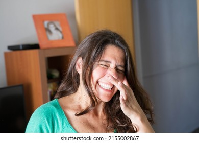 An Attractive Middle-aged Woman With Allergy And Itchy Nose