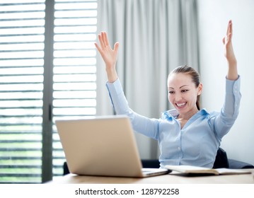 Attractive Mixed Business Woman raising arm with happiness