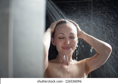 Attractive Mixed Female Taking a Shower with hands in hair