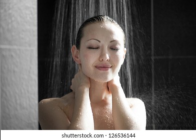 Attractive Mixed Female Taking a Shower touching neck