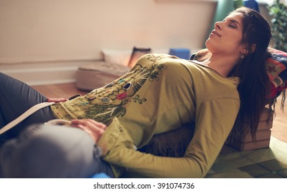 Attractive Mixed Race Woman Doing Restorative Yoga