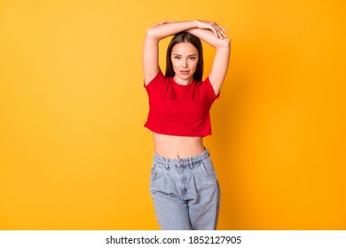 Attractive Model Lady Raise Arms Posing Wear Casual Red Crop Top Jeans Standing Over Yellow Vivid Color Background