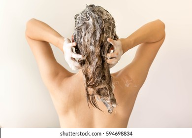 Attractive Model Shampooing Her Long Hair From Behind.