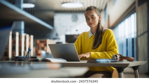 Attractive Multiethnic Student Making a Communication and Journalism Class Homework on a Computer, Researching Answers Online on a Laptop. Young Female Studying in a Public Library - Powered by Shutterstock