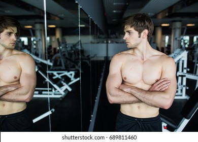 Attractive Muscular Man Admiring His Muscles In Mirror And Checking Workout Results. Summer Ready Beach Body.